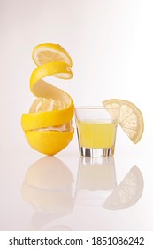 Lemon Peeled Skin And Lemon-flavored Italian Liqueur Limoncello Isolated On White Background.