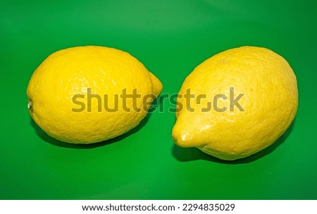 A lemon photographed against a deep green background, adding a touch of freshness and vitality to the image.