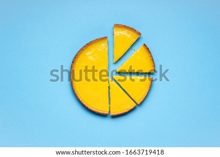 Lemon pie sliced on a blue background. Sliced lemon tart. Delicious sweet food.