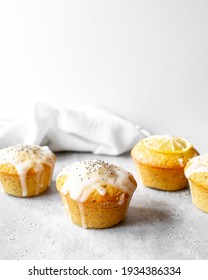 Lemon Poppy Seed Muffins On A Concrete Worktop And Bright Grey Background.