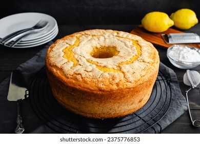 Lemon Pound Cake on a Round Wire Cooling Rack: Pound cake made in a tube pan surrounded by powdered sugar, plates, and more - Powered by Shutterstock