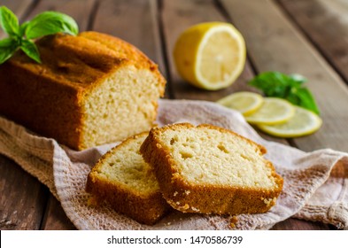 Lemon pound cake on rustic wooden background with lemon