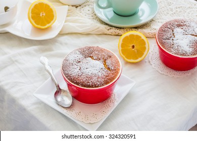 lemon pudding red saucers, tea, english dessert,on a white tablecloth
