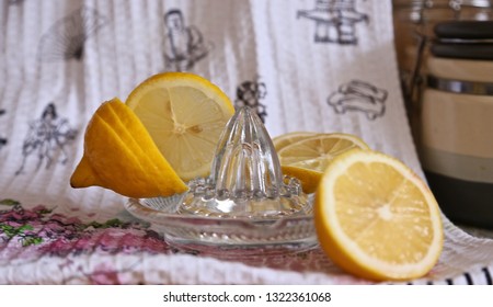 lemon, segments of a lemon and a glass mill for preparation of lemon juice