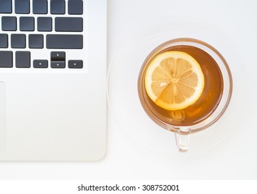 Lemon slice in a cup of tea with notebook, concept of tea time