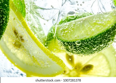 Lemon slice drop in fizzy sparkling water, juice refreshment