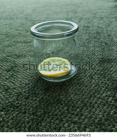 lemon slice inside the jar against greenlight carpet