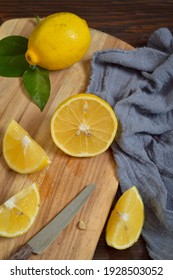 Lemon and its slices on the cutting board 