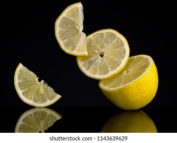 Lemon Slices, Pieces On A Black Background. Unusual Photo. Seem To Defy Gravity 