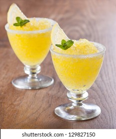 Lemon Slushie Cups Decorated With Mint On Wooden Table