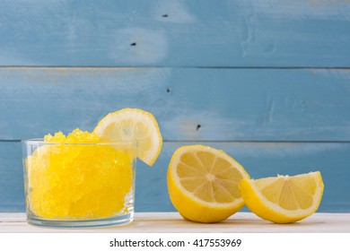 Lemon Slushie In Glass On Blue Wood
