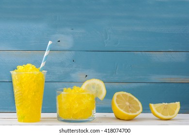 Lemon Slushie In Glass On Blue Wood
