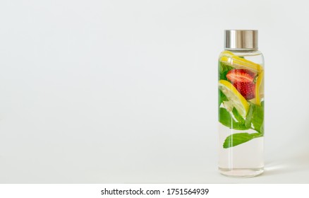 Lemon, Strawberry, Mint Flavored Infused Water. Summer Refreshing Drink. Health Care, Fitness, Healthy Nutrition Diet Detox Concept. White Background, Copy Space.