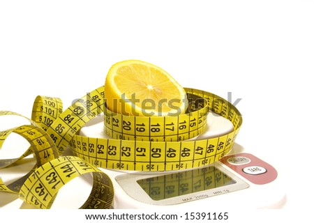Lemon and tape measure on scale isolated