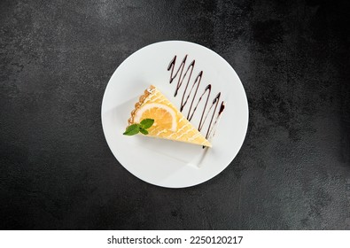 Lemon tart with mint leaves on white plate on black concrete background. Tart with lemon curd in minimal style. Piece of lemon tart. Citrus cheesecake. Sour dessert on dark background - Powered by Shutterstock