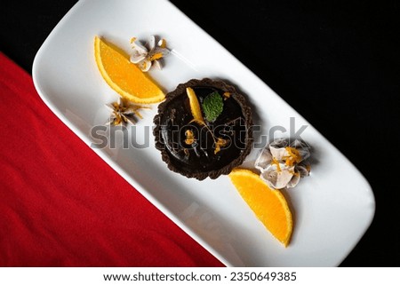 Lemon tart,chocolate tart is a pastry shell with a lemon-chocolate flavored filling. decorated with meringue, Different platting style on black,white,grey plates. check out all the images of tart. 