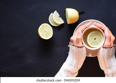 lemon tea with woman wear sweater hands on blackboard background - Powered by Shutterstock