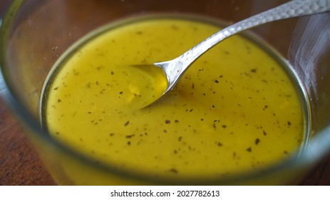 Lemon Vinaigrette Dressing In A Clear Bowl