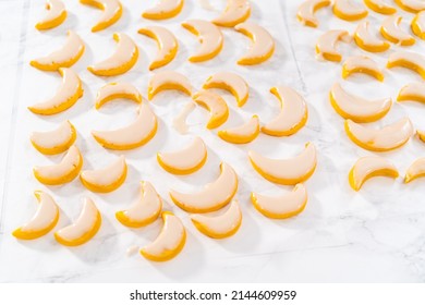 Lemon wedge cookies with lemon glaze. Dipping lemon cookies into a lemon glaze.