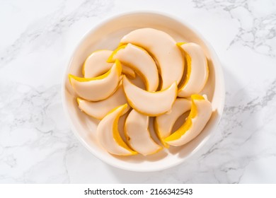 Lemon wedge cookies with lemon glaze. Freshly baked lemon wedge cookies with lemon glaze on a white plate.
