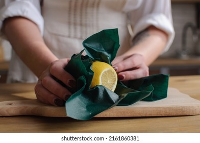 
Lemon Wrapped In Wax Wrap In Female Hands
