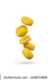 Lemon yellow macaroons are flying on a white background.beautiful yellow macaroons