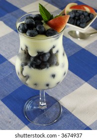 Lemon Yogurt In A Parfait Glass With Blueberries And Nectarines