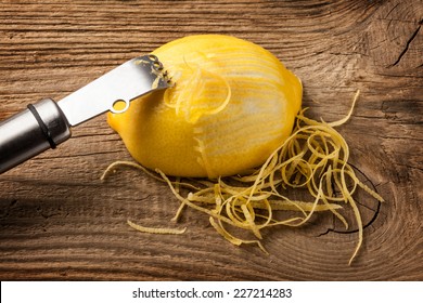 Lemon Zest And Zester On Wooden Board