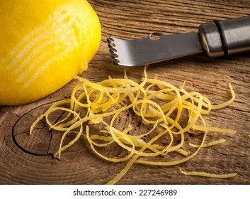 Lemon Zest And Zester On Wooden Board