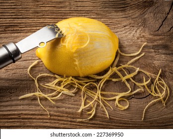 Lemon Zest And Zester On Wooden Board