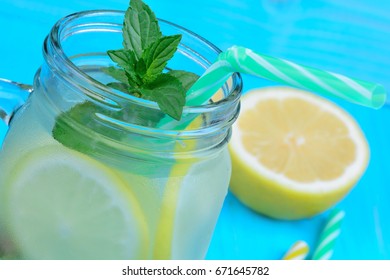 Lemonade in a glass jar on blue wooden table