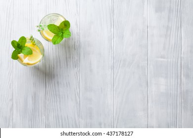 Lemonade glasses with lemon, mint and ice on wooden table. Top view with copy space - Powered by Shutterstock