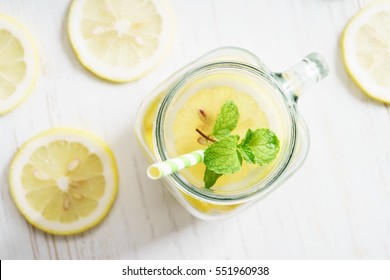 Lemonade In Jar With Fresh Lemon Sliced And Sprig Of Mint, Top View