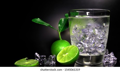 Lemonade juice with lime, fresh summer ice drink, detox water, lemon and lime juice with slices and ice cubes with pitcher and glass - Shutterstock ID 1545061319