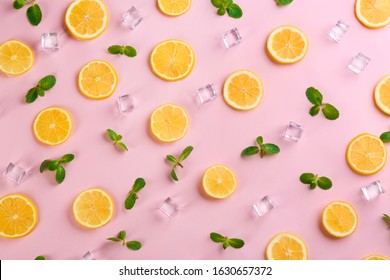 Lemonade Layout With Juicy Lemon Slices, Mint And Ice Cubes On Pink Background, Top View