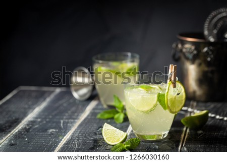 Lemonade or mojito cocktail with lemon and mint, cold refreshing drink or beverage with ice