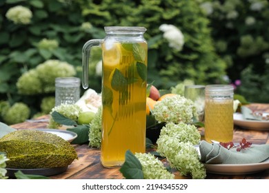 Lemonade On Dining Table Decorated Fresh Flowers And Fruits. Dining Outside, Summer Table Set.