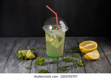 Lemonade In A Plastic Cup.Non Alcoholic Beverage With Lemon And Mint