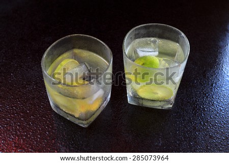 Lemonade served on a dark marble bar top garnished with a lime view 2