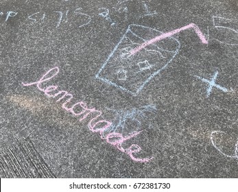 Lemonade Sign On The Sidewalk Pointing To A Kids Lemonade Stand