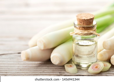 Lemongrass Essential Oil And Fresh Lemongrass On The Wooden Table