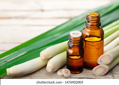 lemongrass essential oil and fresh lemongrass on the wooden table
