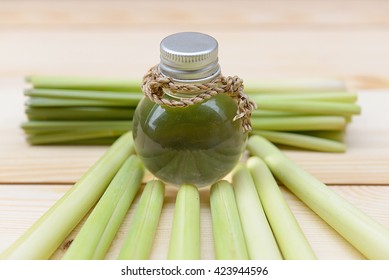 Lemongrass Essential Oil Placed On A Wooden Table. Spa Concept.