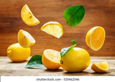 lemons with flying slices on a wood background. tinting. selective focus - Powered by Shutterstock