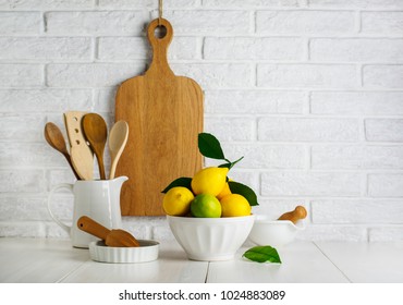 Lemons And Limes In A Bowl On The Table In The Kitchen