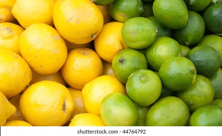  lemons and limes stacked up for sale on a market