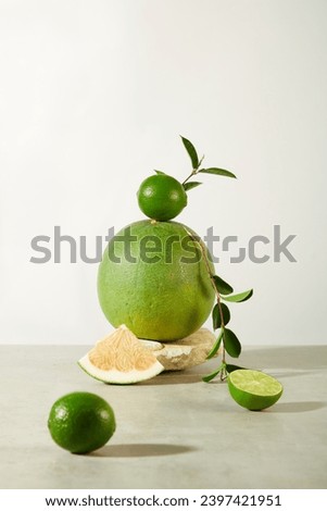 Lemons and pomelo are displayed on a minimalist background. These are two succulent fruits rich in vitamin C. Exquisite space for advertising products with natural extracts.