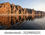 Lena Pillars, Rocks. The most beautiful reserve in Yakutia, Siberia. Beautiful landscapes. Reflection in water, terracotta texture. Golden hour. Journey to rare sights