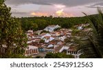 LENCOIS DE BAHIA, BRAZIL: elevated view of historic center,  cobbled streets, traditional houses with white walls and terracotta roof tiles, natural forest surrounding the town