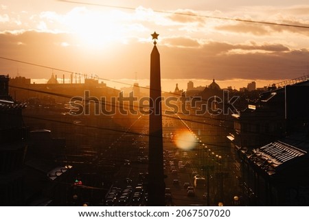 Leningrad Hero City Obelisk on Vosstaniya Square in Saint Petersburg, Russia. Sunset landscape. Cars in traffic jam. Travel destination. Place for vacation. Domes and towers in the background.